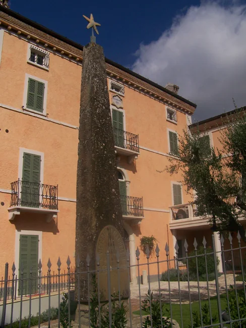 Historic view of Casa Serafini and its monument